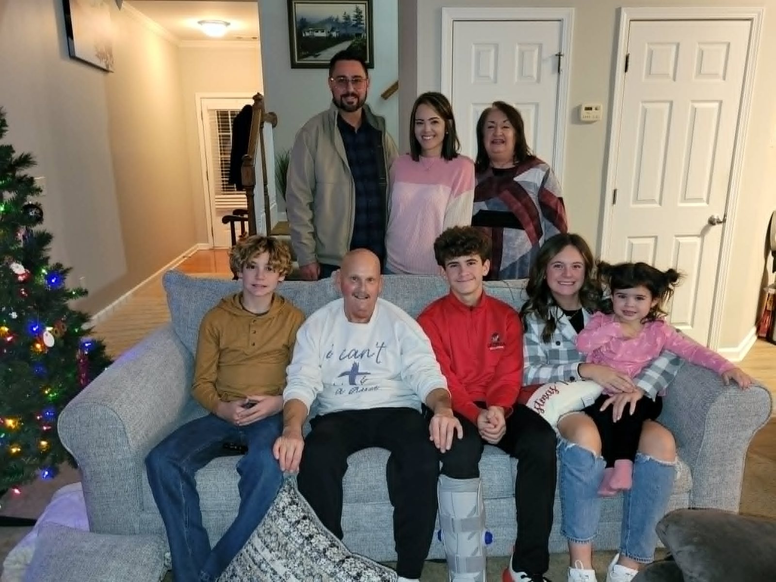 David seated with family at home