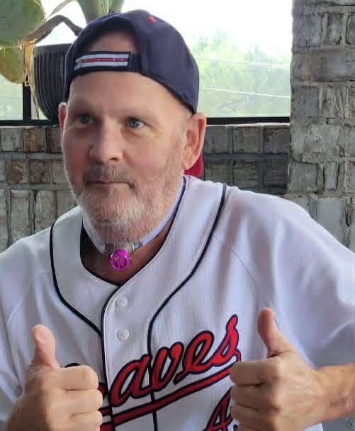 David wearing a Braves baseball jersey and giving two thumbs up