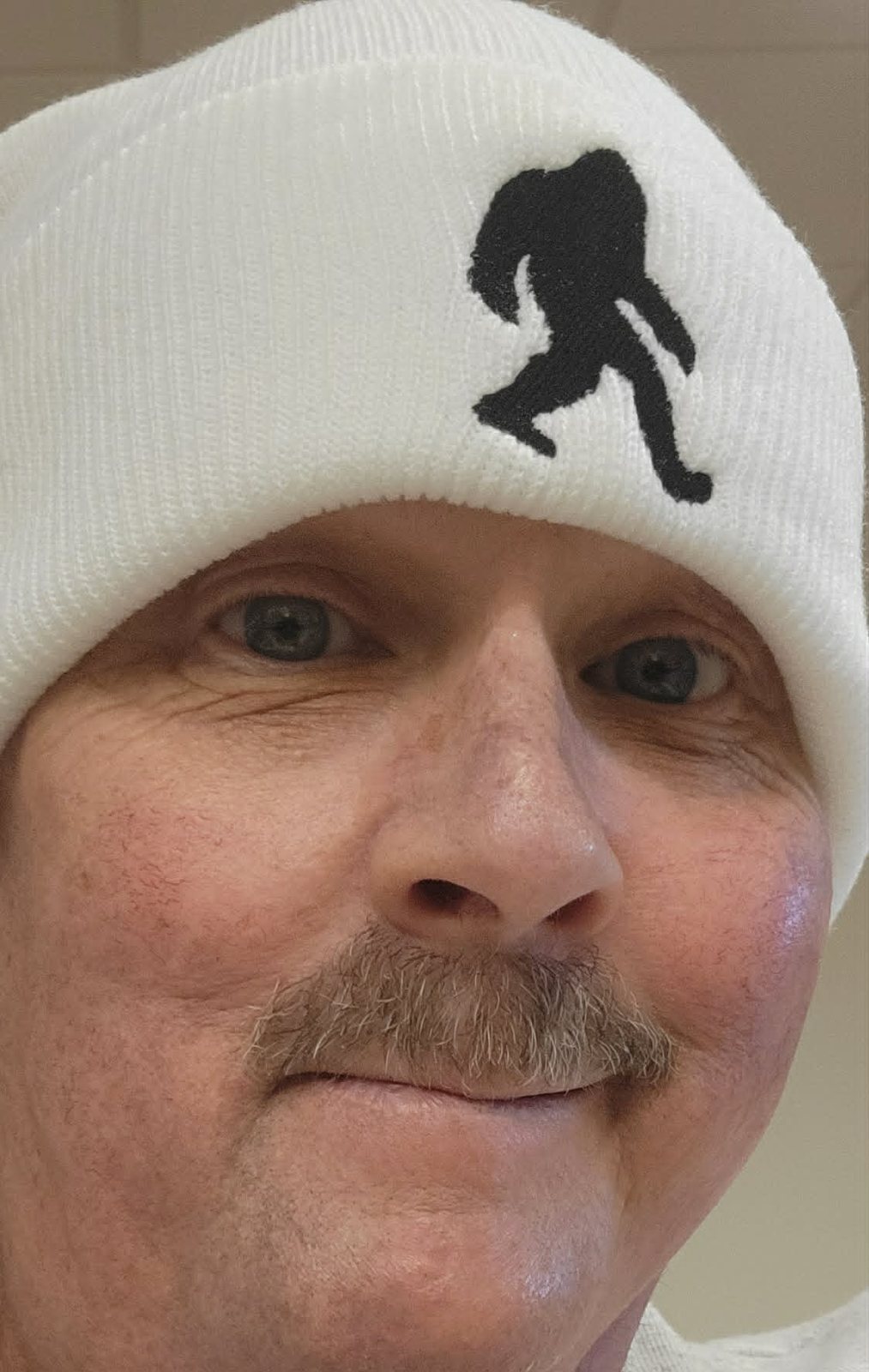 Close portrait of David wearing a white winter hat