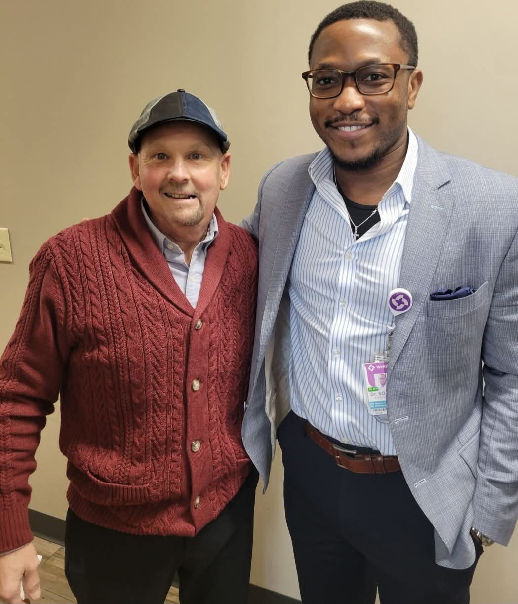 David standing beside Dr. Sokoya during his cancer journey